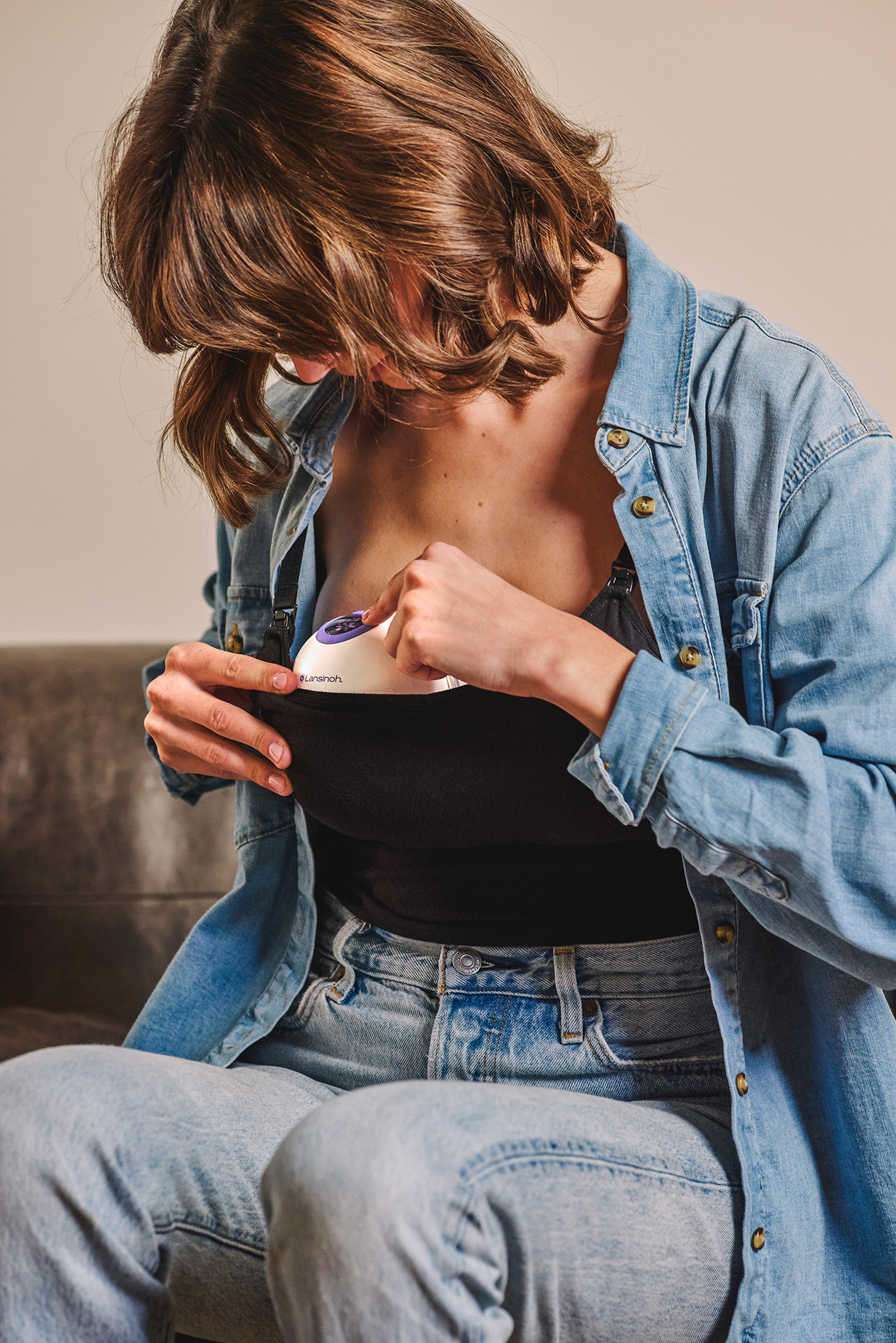 A mother resting with her baby and breast pump
